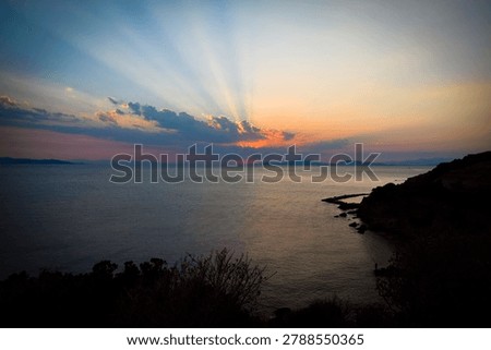 The last rays of the sun setting over the sea horizon