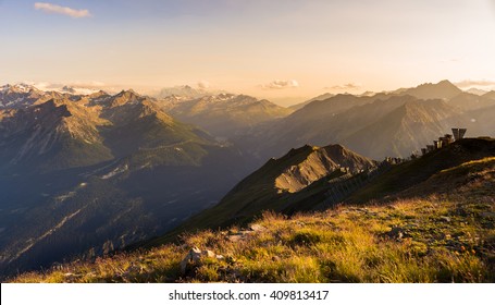 Last soft sunlight over rocky mountain peaks, ridges and valleys of the Alps at sunset. Extreme terrain landscape at high altitude in Valle d'Aosta, scenic travel destination in Italy. - Shutterstock ID 409813417