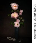 Last of the summer roses, floral still life with beautiful pink fading roses in vase.