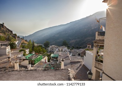 Last sun rays falling over Pampaneira town hills. Alpujarras, Granada, Spain 