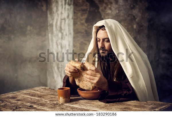 The Last Supper,\
Jesus breaks the bread.