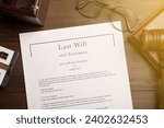 Last Will and Testament, glasses and gavel on wooden table, flat lay