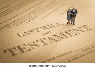 Last will and testament / legacy, inheritance or death tax concept : Miniature elder / old couple stands on a legal document form, depicts preparing to transfer properties to their heirs after death - Shutterstock ID 1260920539