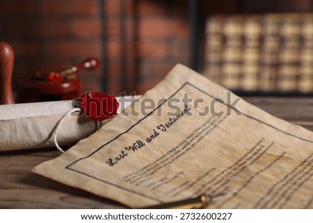 Last Will and Testament and paper scroll on wooden table, closeup