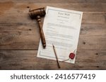 Last Will and Testament with wax seal, gavel and pen on wooden table, top view