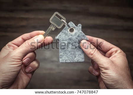 Latchkey in between two hands