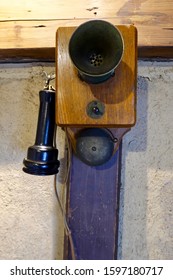 Late 18th Century Phone With Mouthpiece Transmitter Mounted On Wooden Box And Receiver Ear Piece Hanging On Side Switch Hook.