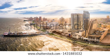 Late afternoon aerial panorama of Atlantic city along the boardwalk. Atlantic City achieved nationwide attention as a gambling resort and currently has nine large casinos.