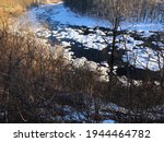 Late Afternoon Light Hits Deerfield River, Rocks Covered in Snow in Shelburne Falls, Massachusetts