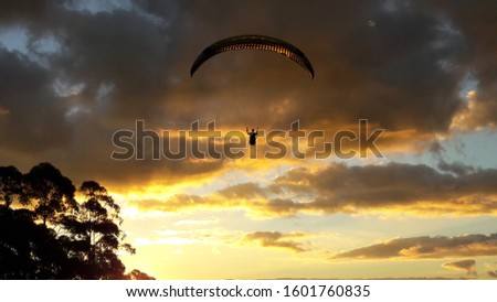 Late afternoon paragliding flight with dramatic sky, in Pocos de Caldas. Poços de Caldas