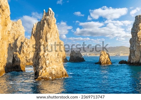 Late afternoon sun highlights the Friars rock formation at Land's End, on the Baja Peninsula at Cabo San Lucas, Mexico.	