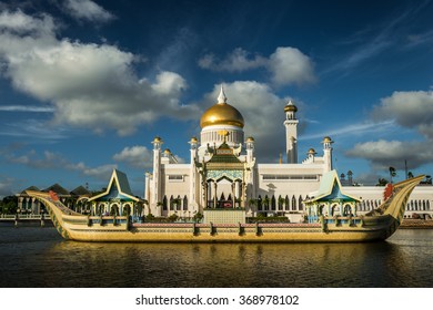 The late afternoon sun sets over Bandar Seri Begawan, Brunei, and strikes the facade of the Sultan Omar Ali Saifuddin Mosque.