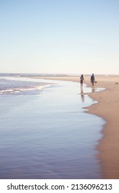 Late Afternoon Walk By The Sea With Pets