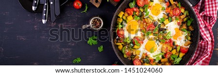 Late breakfast - fried eggs with vegetables. Shakshuka. Arabic cuisine. Kosher food. Banner. Top view