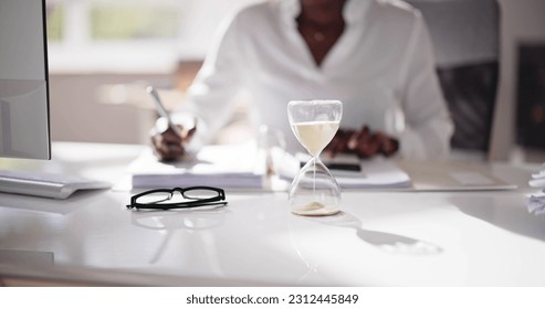 Late Invoice And Billing Deadline With Hourglass At Desk - Shutterstock ID 2312445849