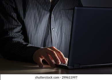 Late Night Internet Addiction Or Working Late Man Using Laptop At A Desk In The Dark