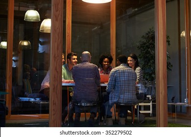 Late Night Meeting Around Table In Design Office