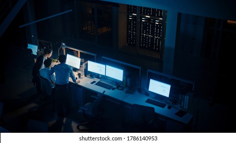 Late at Night In Modern Office: Diverse Team of Successful Businessmen and Businesswomen Gather Around Computer, Have Discussion, Find Problem Solution, Finishing Project Together. High Angle - Shutterstock ID 1786140953