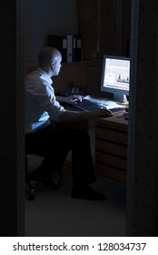 Late Night Office Worker Working Overtime. White Collar Worker Working On Computer At Night In Dark Office.