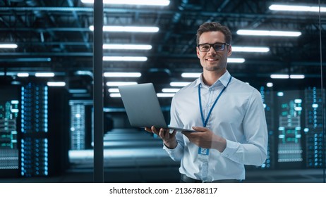 Late at Night in Private Office Male Businessman Works Laptop Computer  He Look at the Camera and Smile  Data Protection Engineering Network for Cyber Security  Business Concept