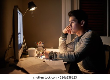 Late Night Study Sessions. Cropped Shot Of A Young Student Studying Late Into The Night.