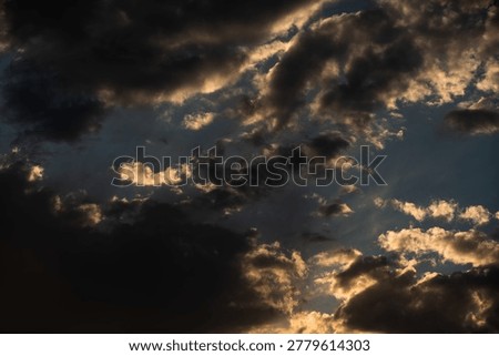 Late-day altocumulus clouds paint an impressionistic tapestry of textured light and shadow at magic hour.
