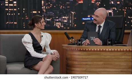 Late-night Talk Show Host Having A Conversation With Celebrity Guest In A Studio. TV Broadcast Style Show