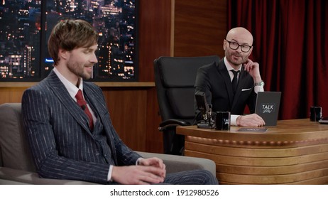 Late-night Talk Show Host Having A Funny Conversation With Celebrity Male Guest In A Studio. TV Broadcast Style Show