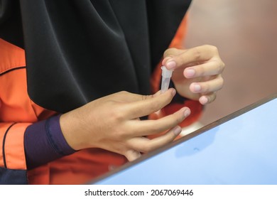 Lateral-Flow-Test Covid Rapid Home-use Test Kit For Saliva - Step 2 - Spit With Mouth Through Funnel In Plastic Tube To Collect Sample.