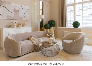 The Latest Fashion Home Trends In An Ultra Modern Elegant Interior Of A Cozy Studio In Soft Pastel Colors. Close-ups Of A Stylish Living Area With Golden Elements