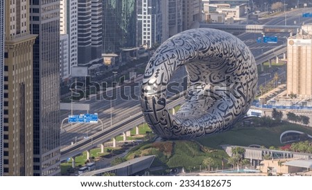 The latest iconic structure in Dubai is the Museum of the Future on the Sheikh Zayed road aerial timelapse. Traffic on a highway and skyscrapers on a background