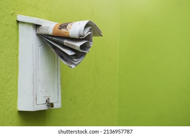 The Latest Paper Delivered Straight To Your Mailbox. Cropped Shot Of Newspapers In A Letter Box.