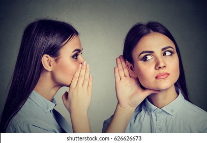Latest rumors. Woman whispering in the ear to herself  - Shutterstock ID 626626673
