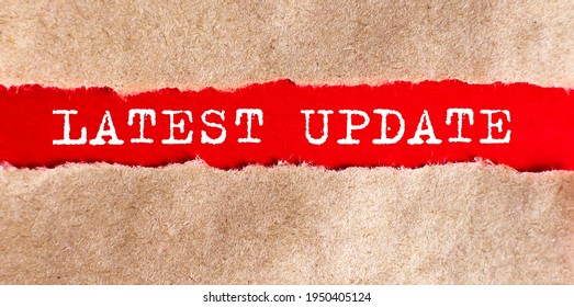 LATEST UPDATE appearing behind torn paper.Business concept - Shutterstock ID 1950405124