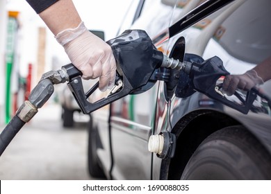 Latex Gloved Hand Pumping Gas