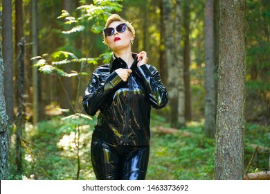 latex rubber fashion woman walking in the forest