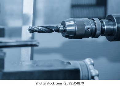 The lathe machine drilling process the metal parts in the light blue scene. The hi-technology metal working processing by CNC turning machine . - Powered by Shutterstock