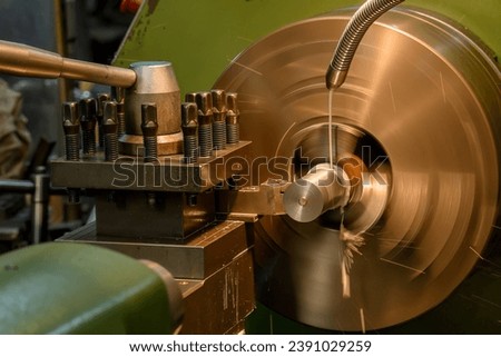 The lathe machine finish cut  metal shaft parts with liquid coolant method. The lathe machine operator setup the coolant tube by hand.