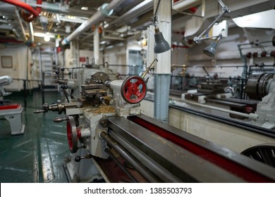 Lathe Machine In Lower Deck Of Vintage Sea Ship Or Boat, Picture Taken In Repair Room, Locksmith's Or Mechanical Workshop Of The Boat Show Vintage Machinery And Tools For Neccesary Repairs On The Sea.