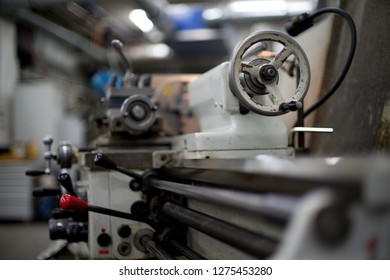 Lathe machine for metal cutting, machinery center background.