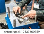 Lathe worker man working with a vernier and milling machine in a factory, using a caliper to check measurement.