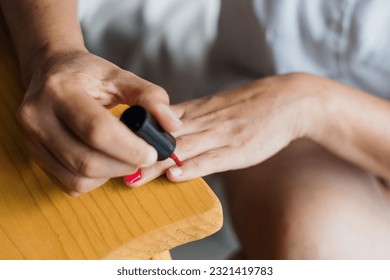 Latin adult woman painting finger nails at home in Mexico Latin America, Hispanic brunette people