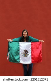 Latin Adult Woman Shows The Flag Of Mexico Proud Of Her Culture And Tradition. Celebrate The Mexican Soccer Team And The National Holidays Of Independence And Cinco De Mayo
