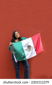 Latin Adult Woman Shows The Flag Of Mexico Proud Of Her Culture And Tradition. Celebrate The Mexican Soccer Team And The National Holidays Of Independence And Cinco De Mayo
