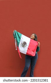 Latin Adult Woman Shows The Flag Of Mexico Proud Of Her Culture And Tradition. Celebrate The Mexican Soccer Team And The National Holidays Of Independence And Cinco De Mayo
