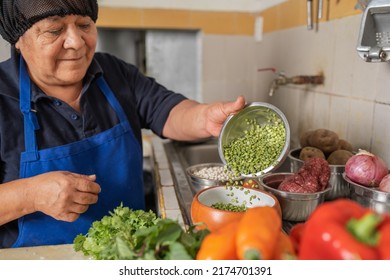 Latin American Adult Woman Preparing Ingredients For A Ceviche In A Restaurant Kitchen