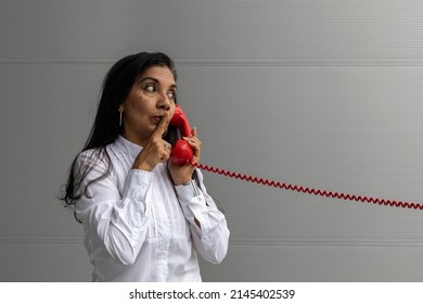 Latin American adult woman with a red headset posing on camera. Vintage technology concept
