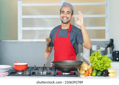 Latin American Chef With Apron Loves Cooking At Kitchen Of Restaurant