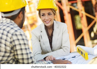 Latin American Construction Worker And Female Architect Talking. Copy Space