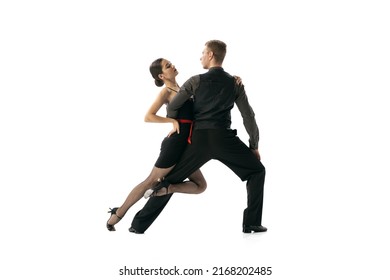 Latin American Dances. Beautiful Sportive Young Man And Woman Dancing Argentine Tango Isolated On White Studio Background. Concept Of Art, Beauty, Grace, Action, Emotions. Copy Space For Ad